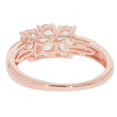 Rose gold side view of an oval pink morganite sterling silver ring with delicate accents.